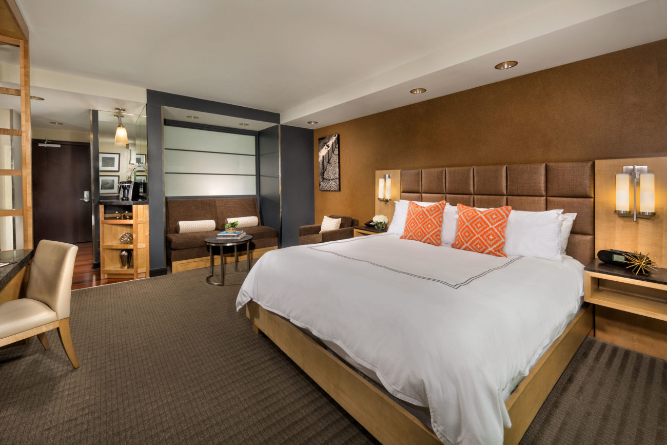 A king bedroom featuring a comfortable bed, work desk & more at the Hotel at Arundel Near BWI Airport