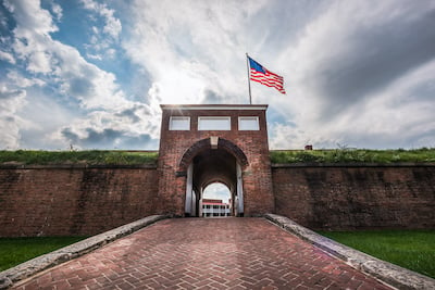 Historic American flying over the entrance to Fort McHenry National Monument, Baltimore, Maryland