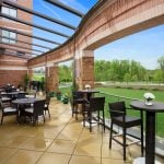 A large deck with tables and chairs at the Hotel at the Arundel Preserve located near the Arundel Mills Mall