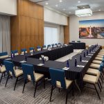 Meeting room with long tables and lots of chairs