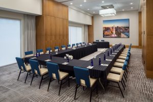 Meeting room with long tables and lots of chairs
