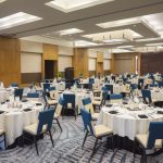 a spacious meeting venue set up with tables and chairs