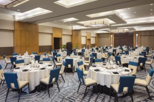a spacious meeting venue set up with tables and chairs