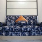 blue and white couch sitting in a room