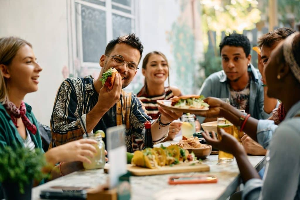 Friends enjoying food - Image credit Shutterstock Drazen Zigic