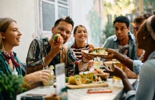 Friends enjoying food - Image credit Shutterstock Drazen Zigic