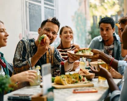 Friends enjoying food - Image credit Shutterstock Drazen Zigic